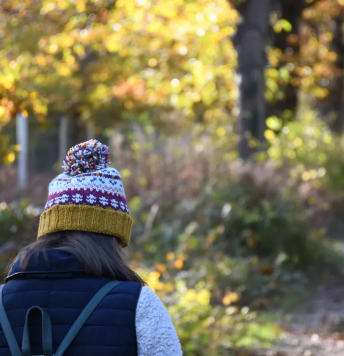 Person wearing a fluffy beanie hat in nature - Tim Horton