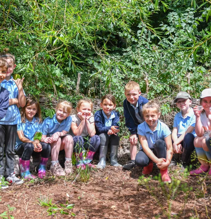 school visit kids smiling with pond dipping equipment