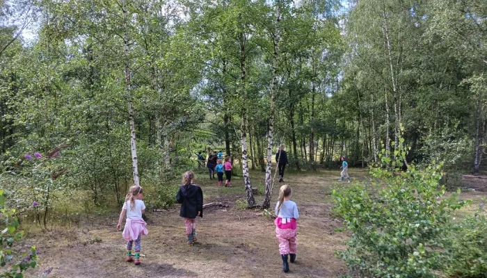 children being led into the forest for activities