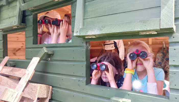 Kids looking for birds with binoculars at Holiday Club