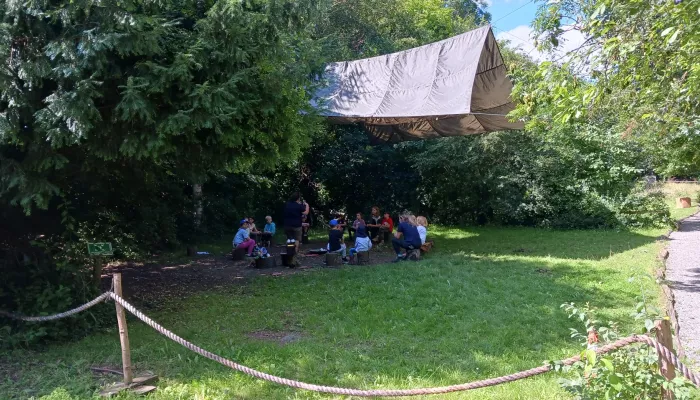 A forest school group underneath a shelter