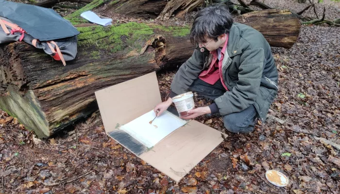 A person setting up a track plate.