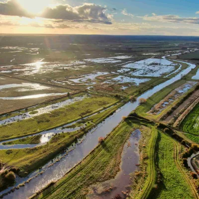 A photo from above Minster Marshes, showing the water glowing in the sun.