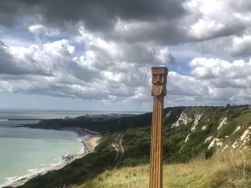 Perkunas totem pole with views from the top of capel-le-ferne cliffs down to the english channel