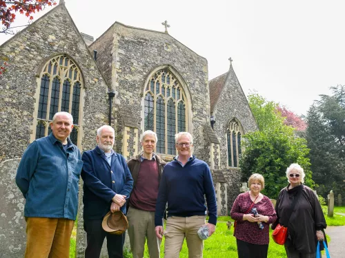 St Clement's churchyard volunteers posing with rob smith for the talk on the wild side podcast episode